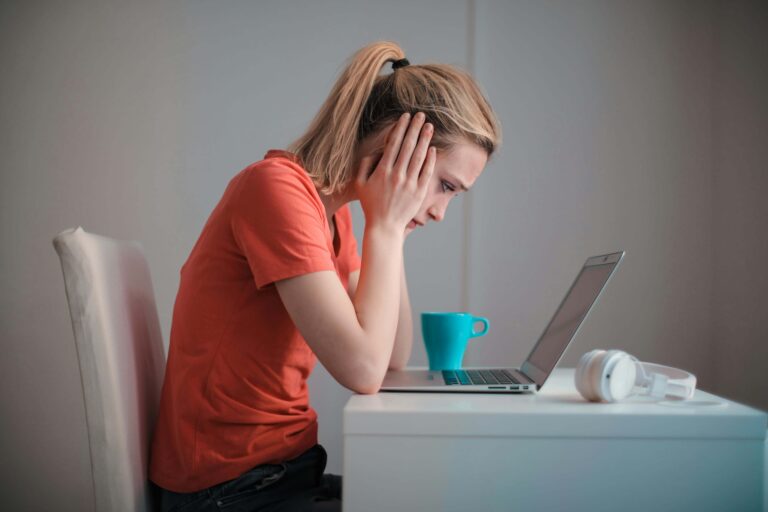 Image of a person deeply focused on their work in a clean, organized workspace.